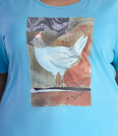 Close up of JunoActive's Designer Graphic scoop neck top with bird print on color mountain lake blue. 