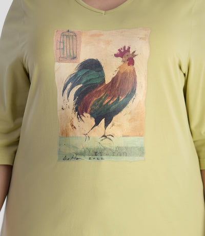 Close up of model wearing JunoActive's designer graphic 3/4 sleeve v-neck tunic in color aloe green. Print has a rooster on it with unique paint brush texture.