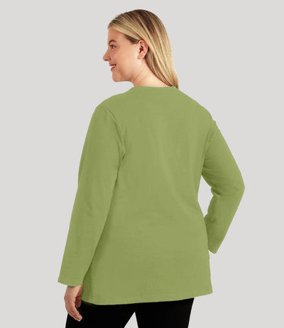 Plus size woman, facing back, wearing JunoActive's Designer Graphic Long Sleeve Scoop Neck Plus Size Top. Back is blank in the color aloe green.