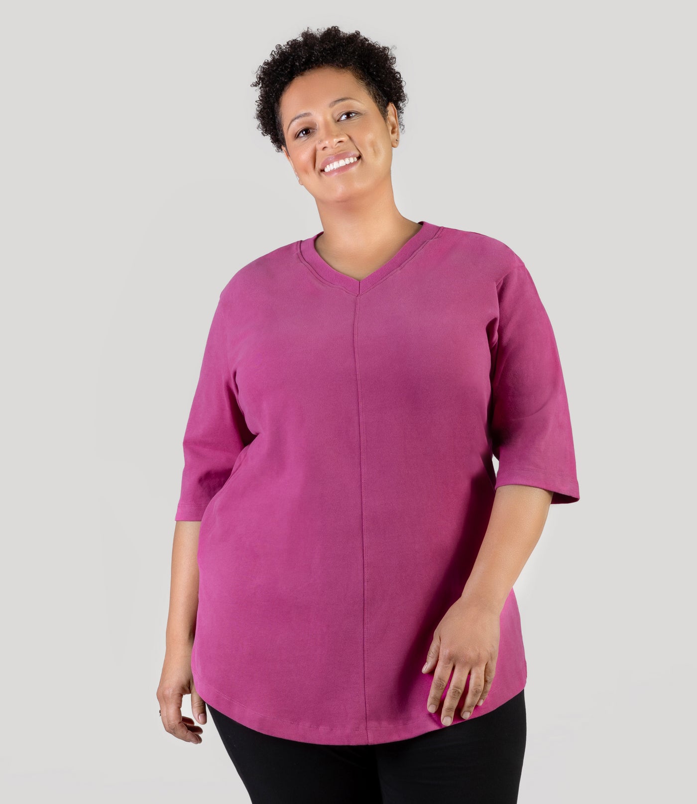 Plus size model, facing front, wearing JunoActive's Legacy Cotton Casual plus size tunic top
 in color magenta rose.