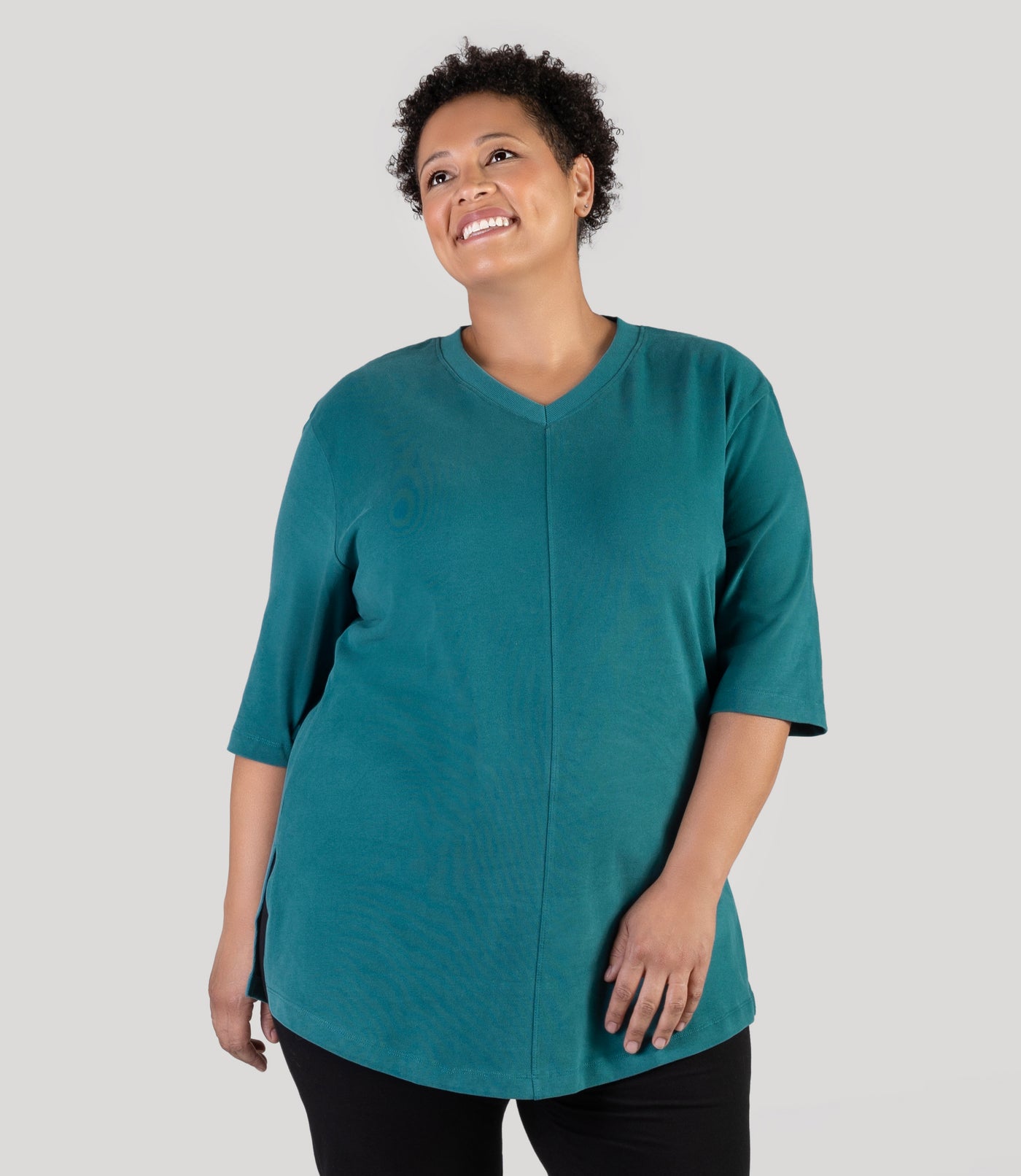 Plus size model, facing front, wearing JunoActive's Legacy Cotton Casual plus size tunic top in jasper teal color.