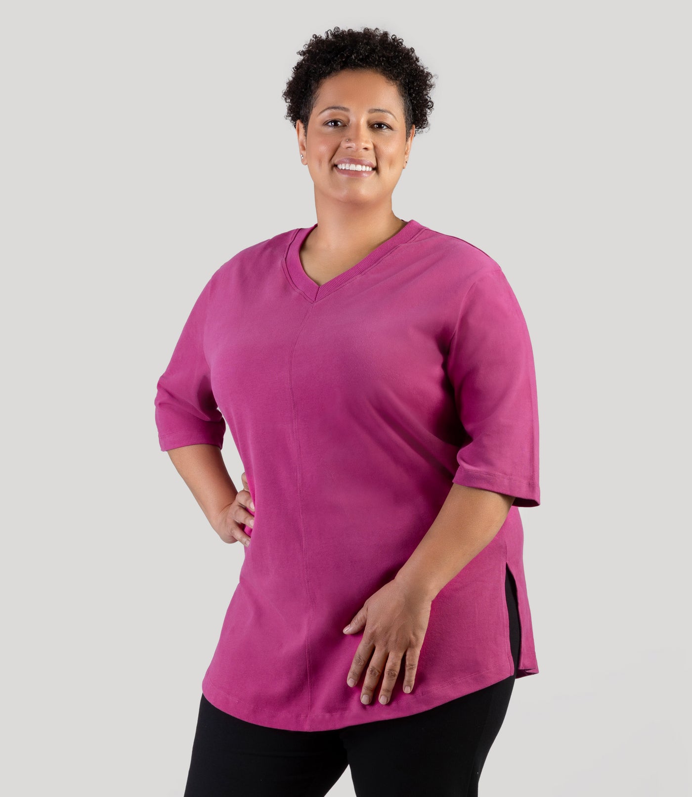 Plus size model, facing front with side slit showing, wearing JunoActive's Legacy Cotton Casual plus size tunic in color magenta rose.