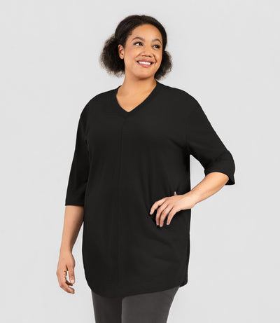 Plus size woman, facing front, wearing JunoActive's Legacy Cotton Plus Size Casual Tunic in color black.