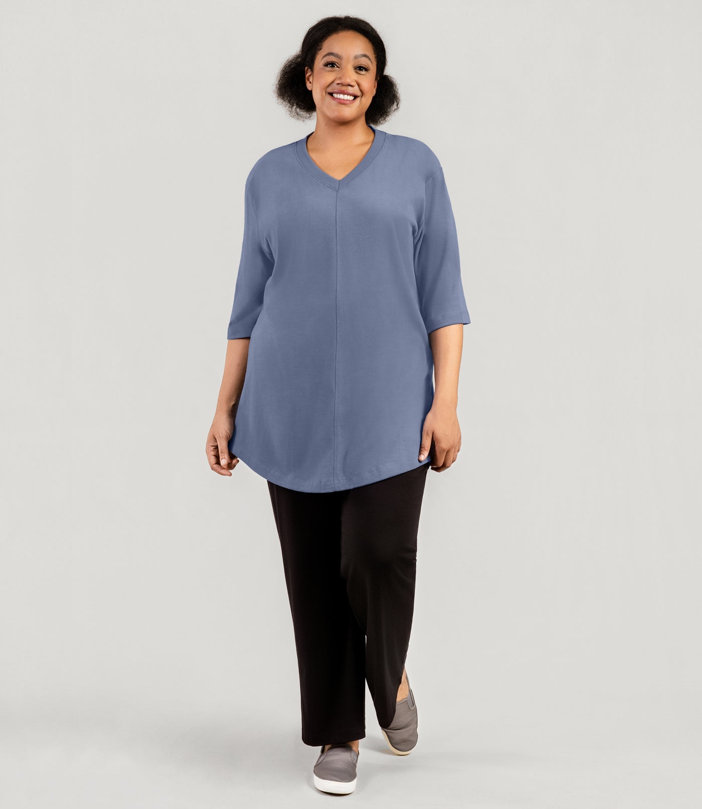 Plus size model, facing front full body shot, wearing JunoActive's Legacy Cotton Casual plus size tunic top in color blue steel.