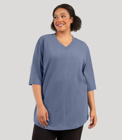 Plus size model, facing front, wearing JunoActive's Legacy Cotton Casual plus size tunic top in color blue steel.