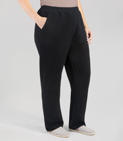 Bottom half front view of plus sized woman wearing Junoactives Legacy Cotton Casual Pant with pockets. These pants are full length and pockets on each side in solid black.