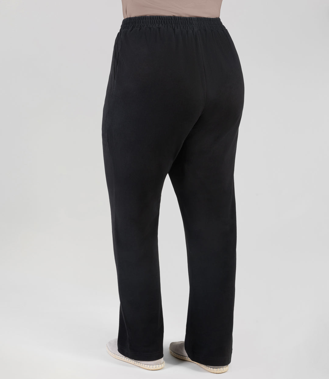 Bottom half back view of plus sized woman wearing Junoactives Legacy Cotton Casual Pant with pockets. These pants are full length and pockets on each side in solid black.