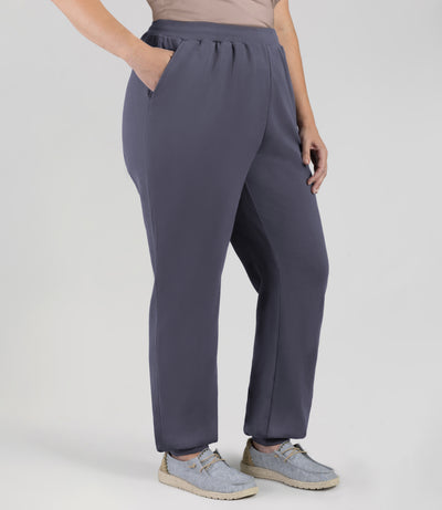 Plus size model wearing JunoActive's Legacy Cotton Casual Pocketed Jogger in color Misty Grey. She's facing front with right hand in pocket of jogger and left hand by side.