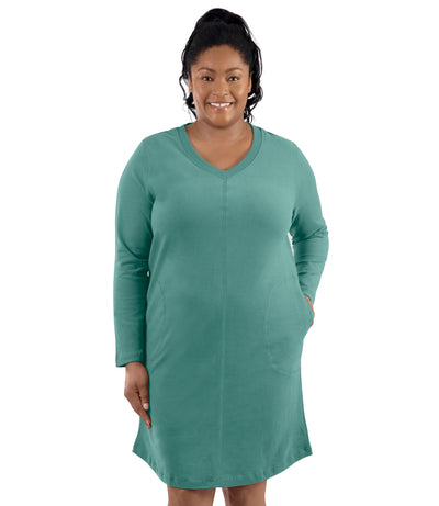 Plus-size model, facing forward, left hand in dress pocket. Wearing JunoActive's Legacy Cotton Casual Pocketed Long Sleeve Dress in Lichen Green.