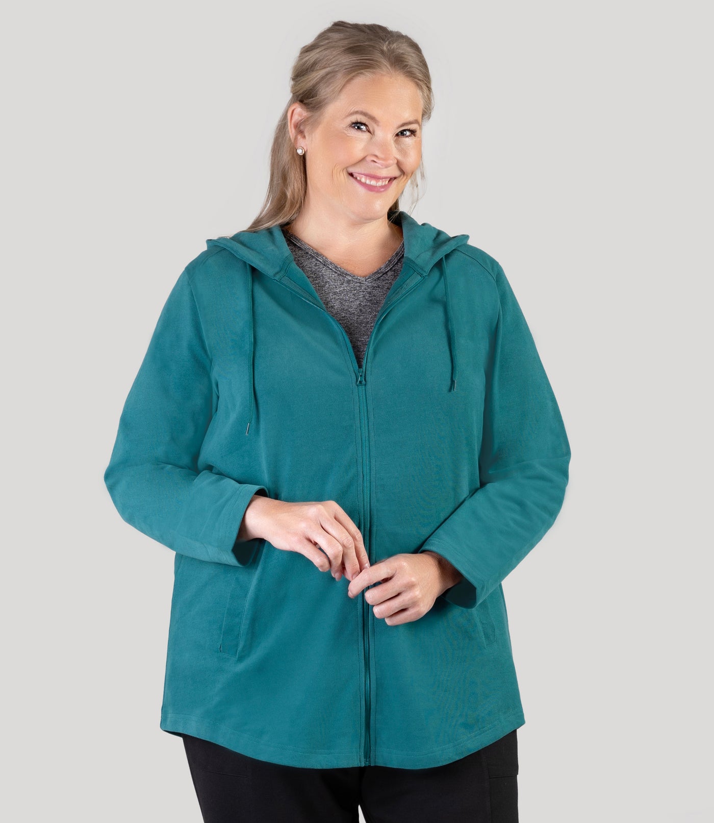 Plus size model, facing front, wearing JunoActive's Legacy Cotton Casual Zip Front plus size hoodie in color Jasper Teal.