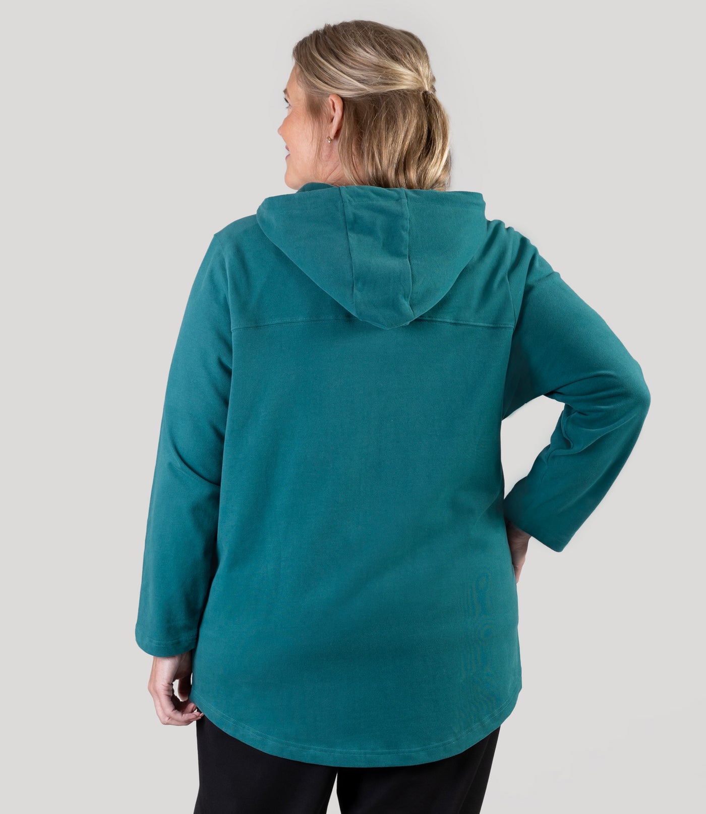 Plus size model, facing back, wearing JunoActive's Legacy Cotton Casual Zip Front plus size hoodie in color Jasper Teal.