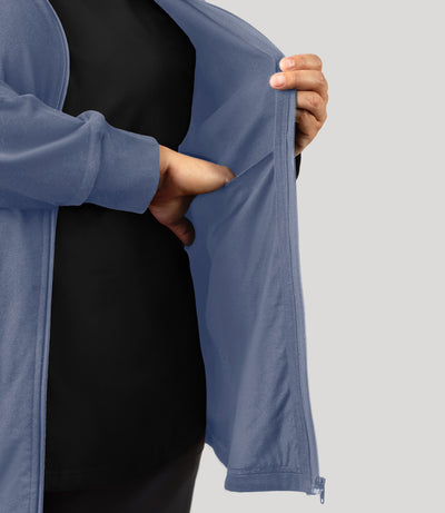 Plus size woman, close up shot of inside pocket of jacket, wearing JunoActive's Legacy Cotton Casual Mock Neck Zip up plus size jacket in color blue steel. Jacket is unzipped.