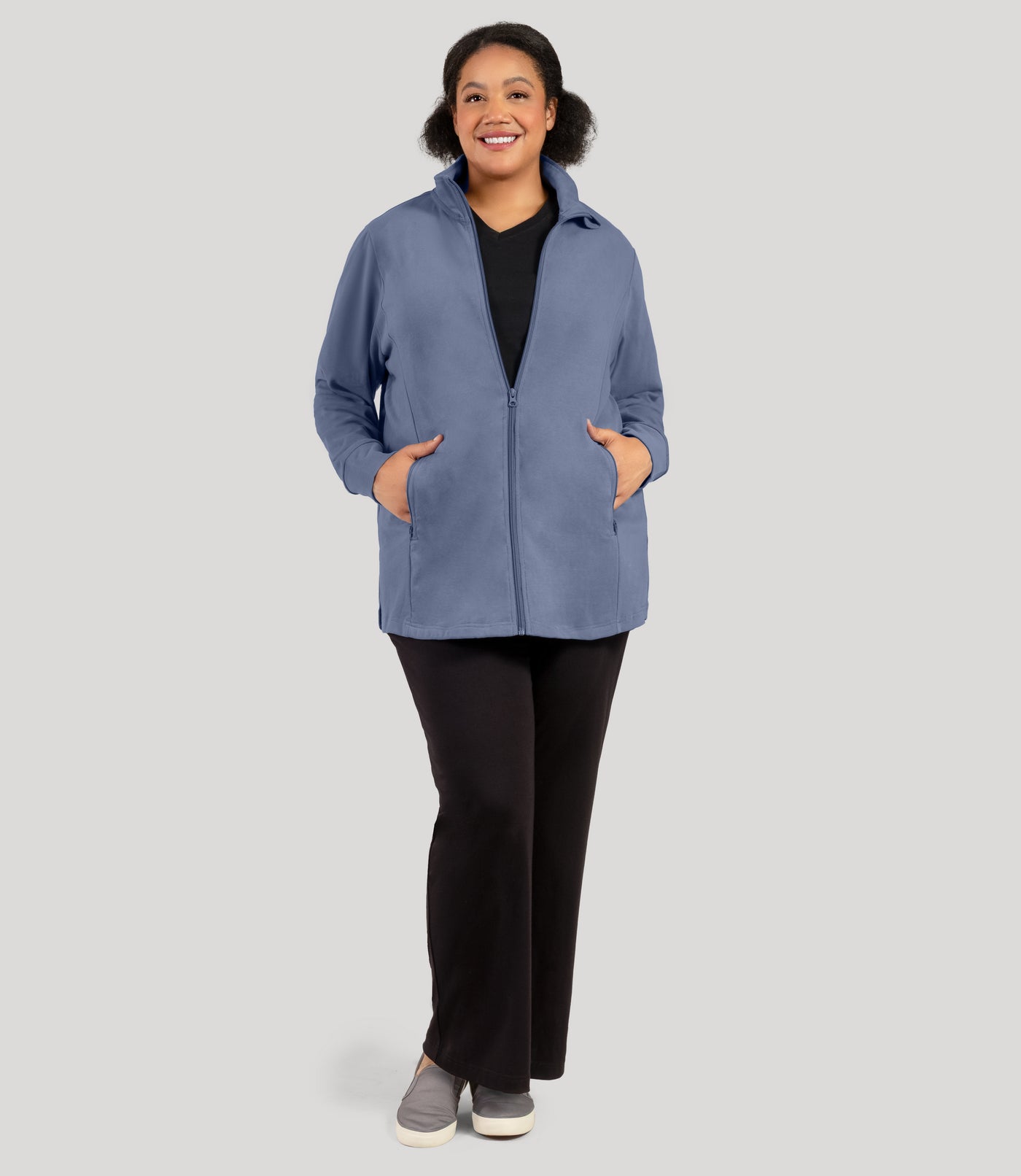 Plus size woman, facing front and full length shot, wearing JunoActive's Legacy Cotton Casual Mock Neck Zip up plus size jacket in color blue steel. Jacket is zipped.