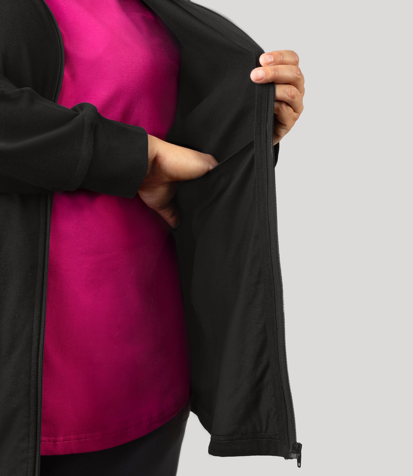 Plus size woman, facing front and close up shot of hand inside pocket of inner jacket, wearing JunoActive's Legacy Cotton Casual Mock Neck Zip up in color black. 