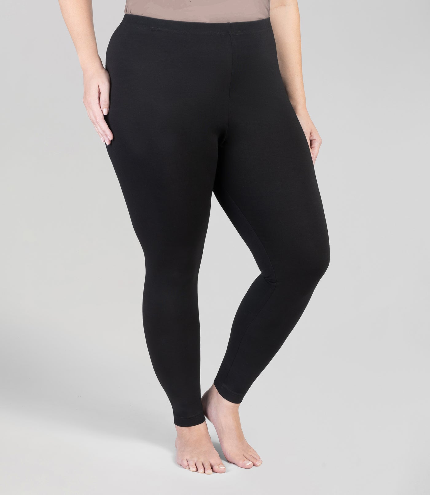 Bottom half of plus sized woman, front view, wearing JunoActive Stretch Naturals Leggings in color black. Bottom hem is at the ankle. 