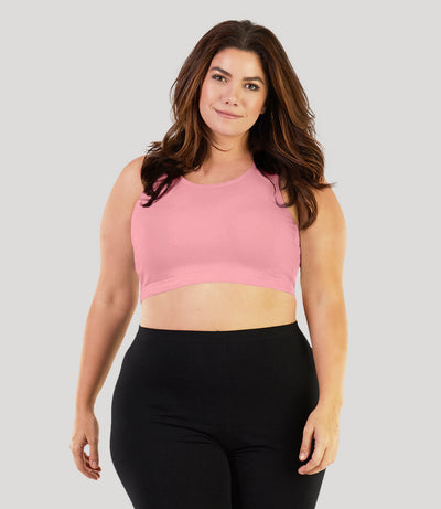 Plus size model, facing front, wearing stretch naturals Scoop Neck bra in color peach fizz.