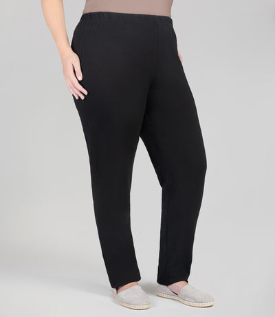 Front view, plus sized woman, wearing JunoActives Stretch Naturals Fit Leggings in black. Her left hand is resting on her left leg and right hand on hip. The pant is full length.