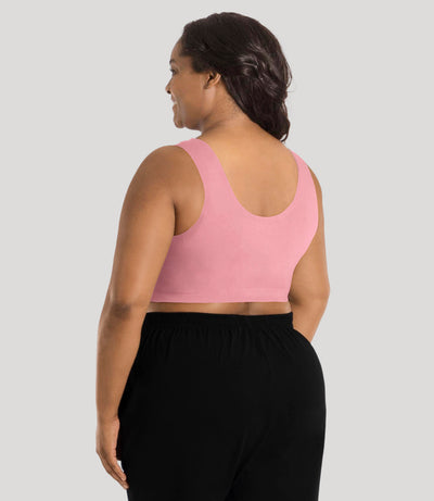 Plus size model, facing back, wearing stretch naturals full fit scoop neck bra in color peach fizz.