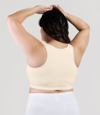 Plus size model, facing back, wearing stretch naturals full fit V-neck plus size bra in color sandy.
