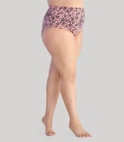 Model, facing side, wearing Junowear Cotton Stretch Classic Full Fit Brief Flower Prints in color pink and black flower. Model is on her tip-toes.