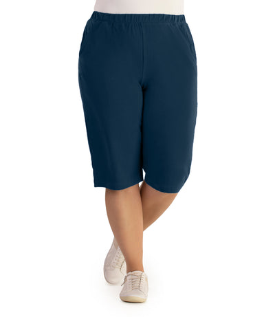 JunoActive Model, facing front, wearing Stretch Naturals Bermuda Shorts Classic Colors-Bottoms in color Indigo.