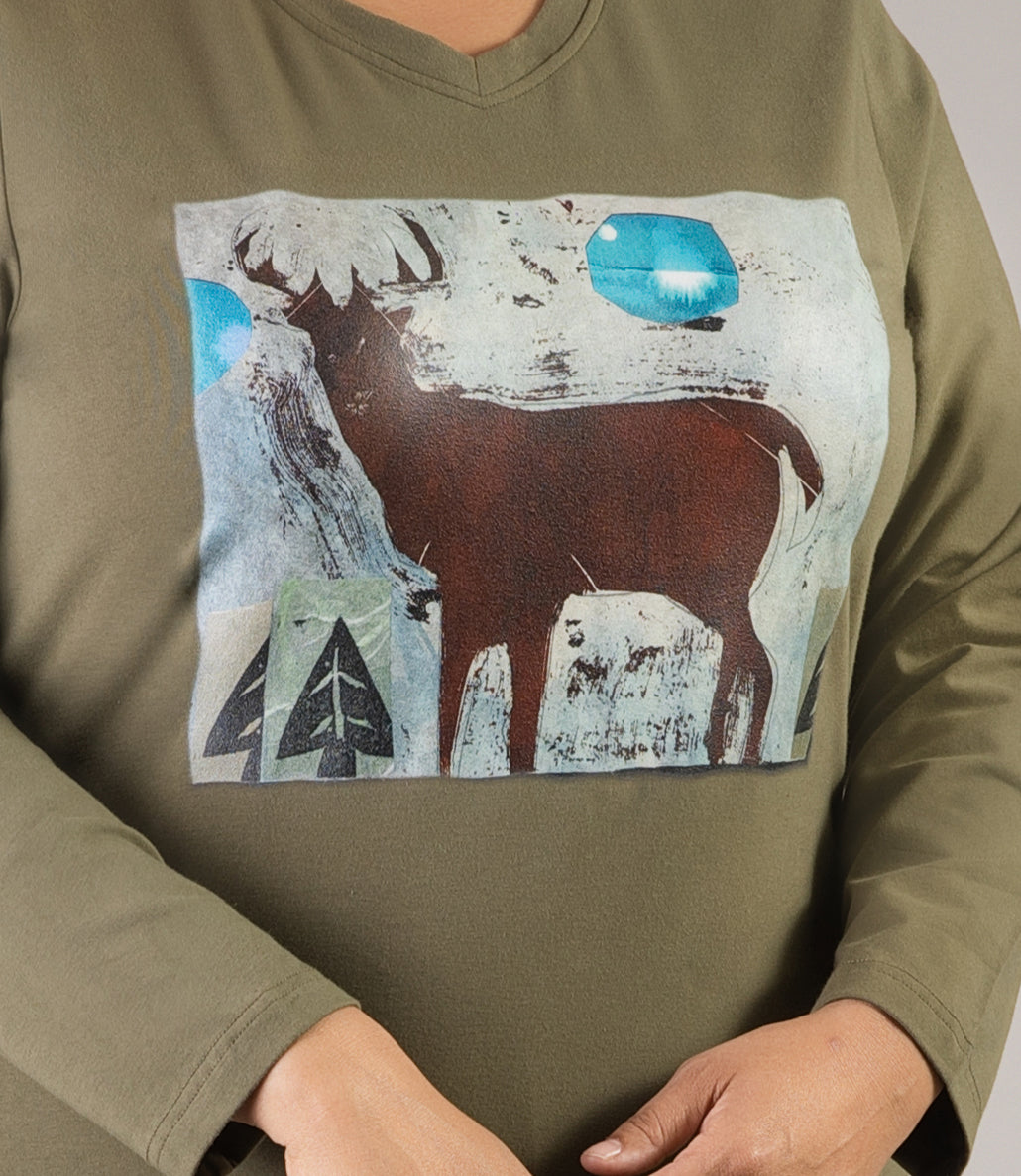 close up of graphic. JunoActive plus size Stretch Naturals Long Sleeve V-Neck Top in the color Moss Green with a moose graphic. Moose, moon and trees with a textured backdrop.