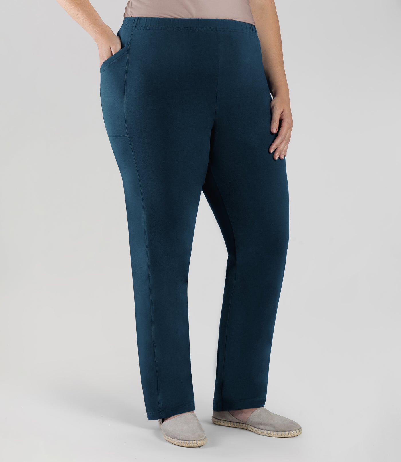 Bottom half of plus sized woman, front side view, wearing JunoActive Tall Stretch Naturals Side Pocket Loose Fit Leggings in color indigo. Bottom hem is at the ankle.