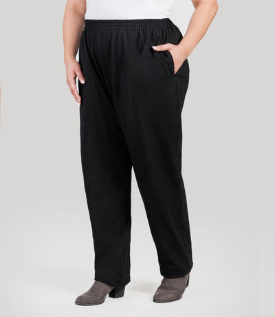 Plus size model, facing front, lower half of body from waist down, wearing JunoActive's Stretch Naturals Full Fit Pear plus size Pant in color black.