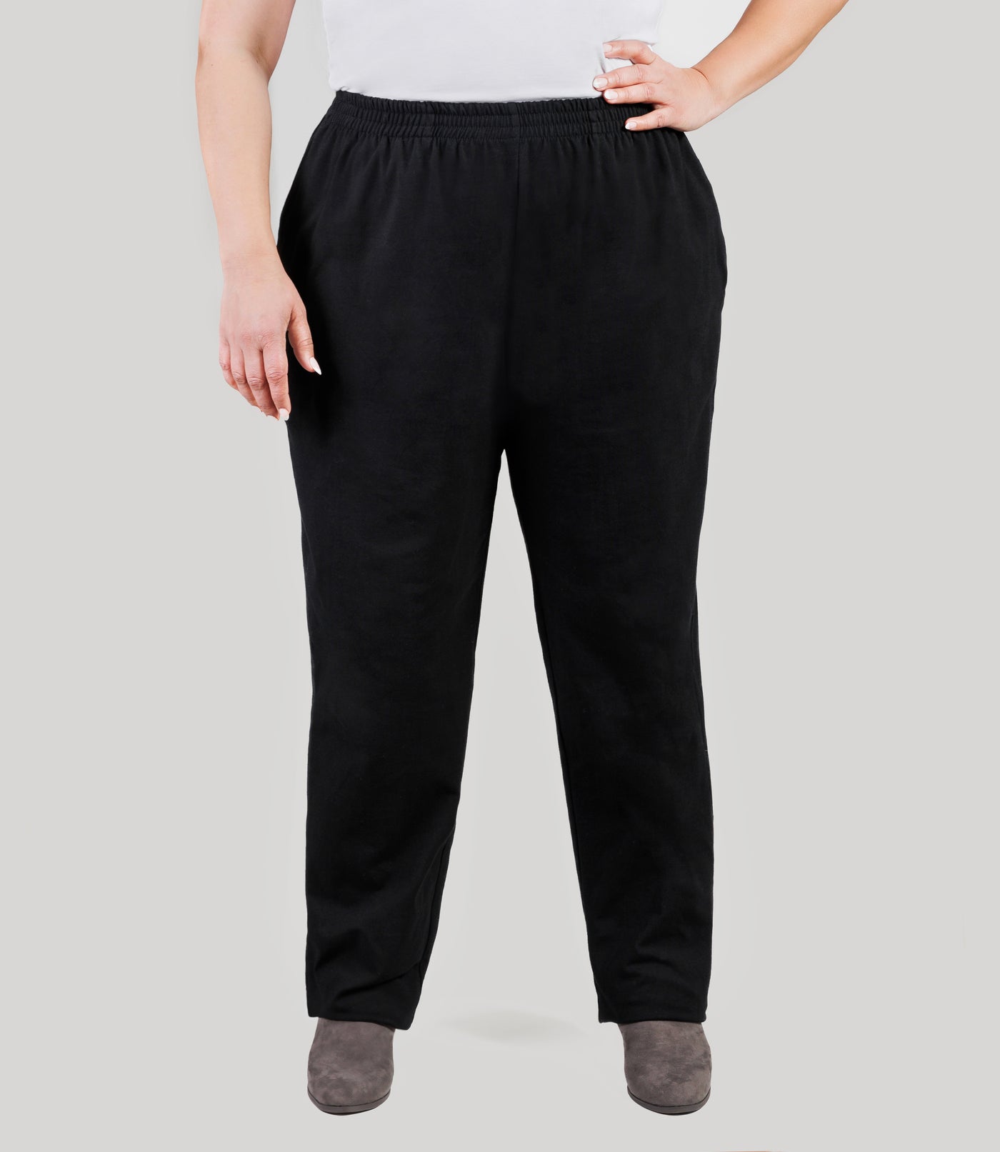 Plus size model, facing front, lower half of body from waist down, wearing JunoActive's Stretch Naturals Full Fit Pear plus size Pant in color black.