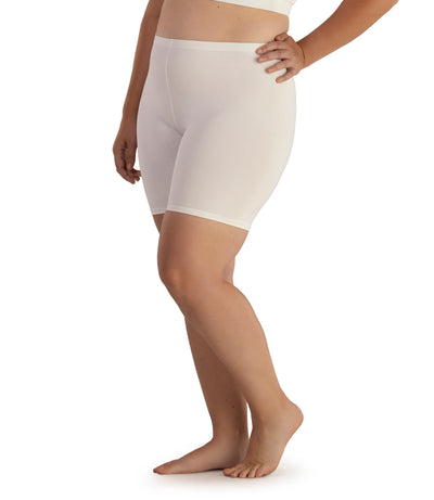 Bottom half of plus sized woman, facing side, wearing JunoActive Junowear Hush Boxer Brief in color white. This fitted boxer fits to the waistline and leg opening is a few inches above the knee.