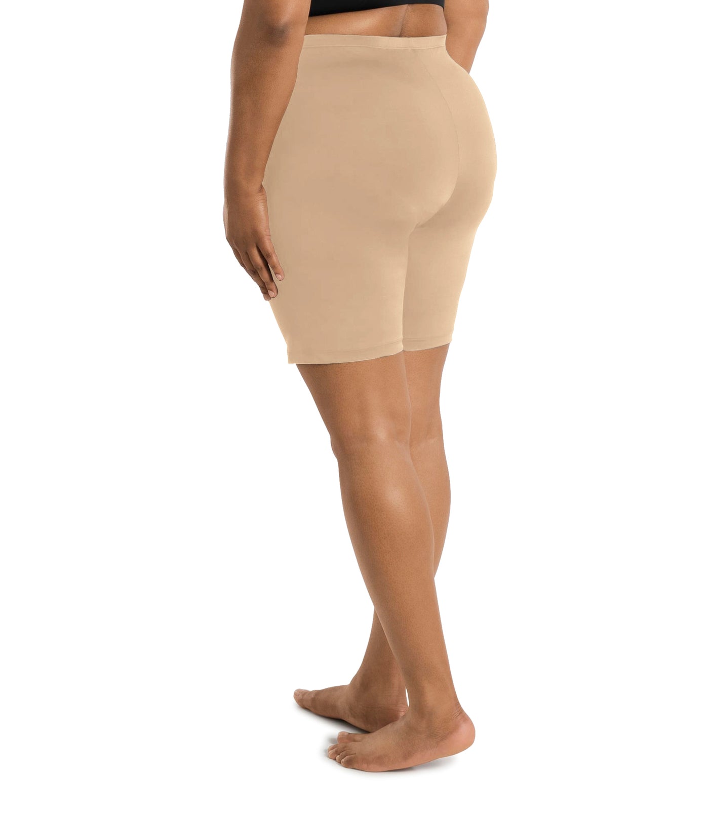 Plus size woman wearing JunoActive's hush full fit boxer in color ecru. Model is facing back with hands to her side.