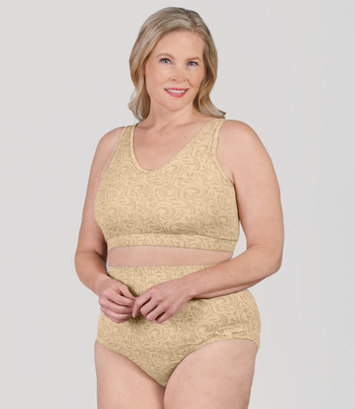 Plus size woman, facing front, wearing JunoActive's Junowear Hush Plus V-neck plus size Bra in ecru swirl print.