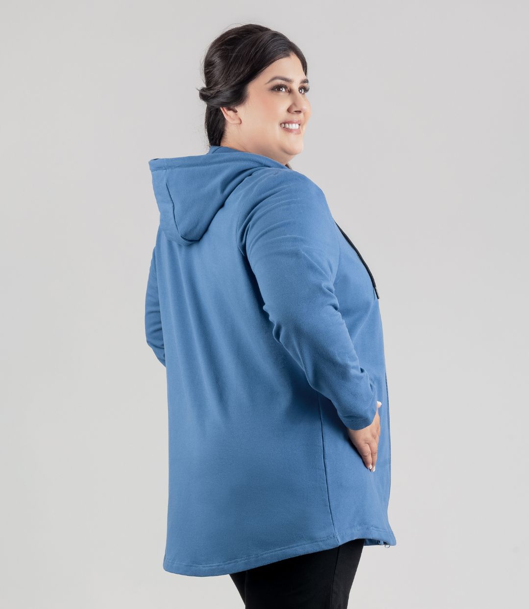 Model facing back, wearing JunoActive's MaVie Zip Front Hoodie in Dusk Blue. Hands in pockets of hoodie