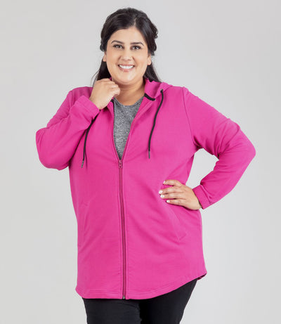 Model facing front, wearing JunoActive's MaVie Zip Front Hoodie in Magenta Pink. Left arm of models hand on hip and right hand holding collar of shirt.