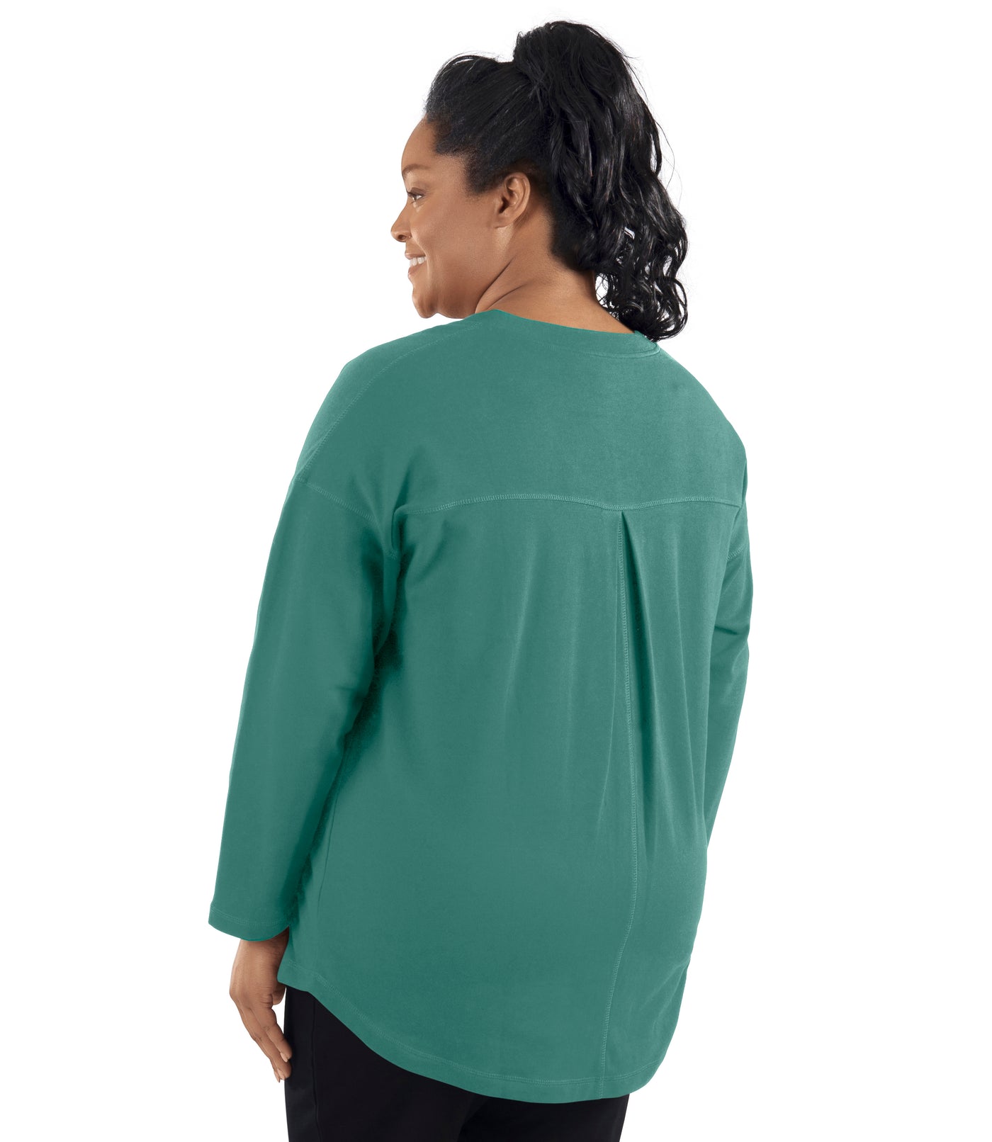 Plus-size model, facing back, wearing JunoActive's Mavie Drop Shoulder V-neck Tunic in Baltic Blue Green.