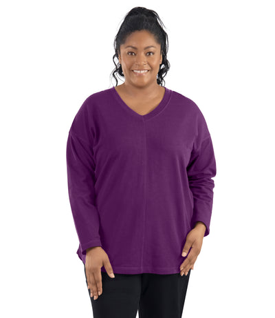 Plus-size model, facing forward, wearing JunoActive's Mavie Drop Shoulder V-neck Tunic in Magenta Purple.
