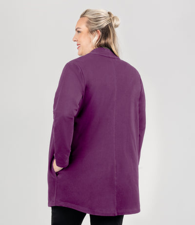 Model is facing back, wearing JunoActive's Mavie Cotton Long Wrap Jacket in color aubergine. 