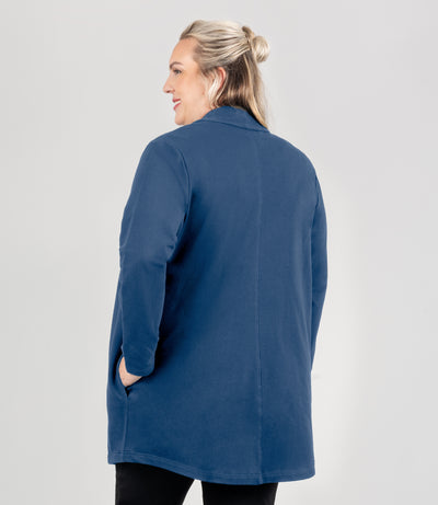 Model is facing back, wearing JunoActive's Mavie Cotton Long Wrap Jacket in color stormy blue. 