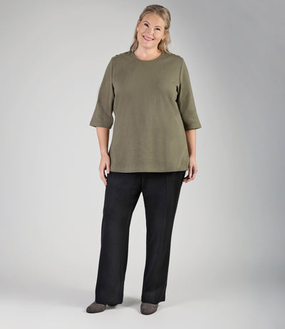 Full body image of plus size woman, facing front, wearing JunoActive's Ponte Center Seam Pocketed plus size pant in color black. 