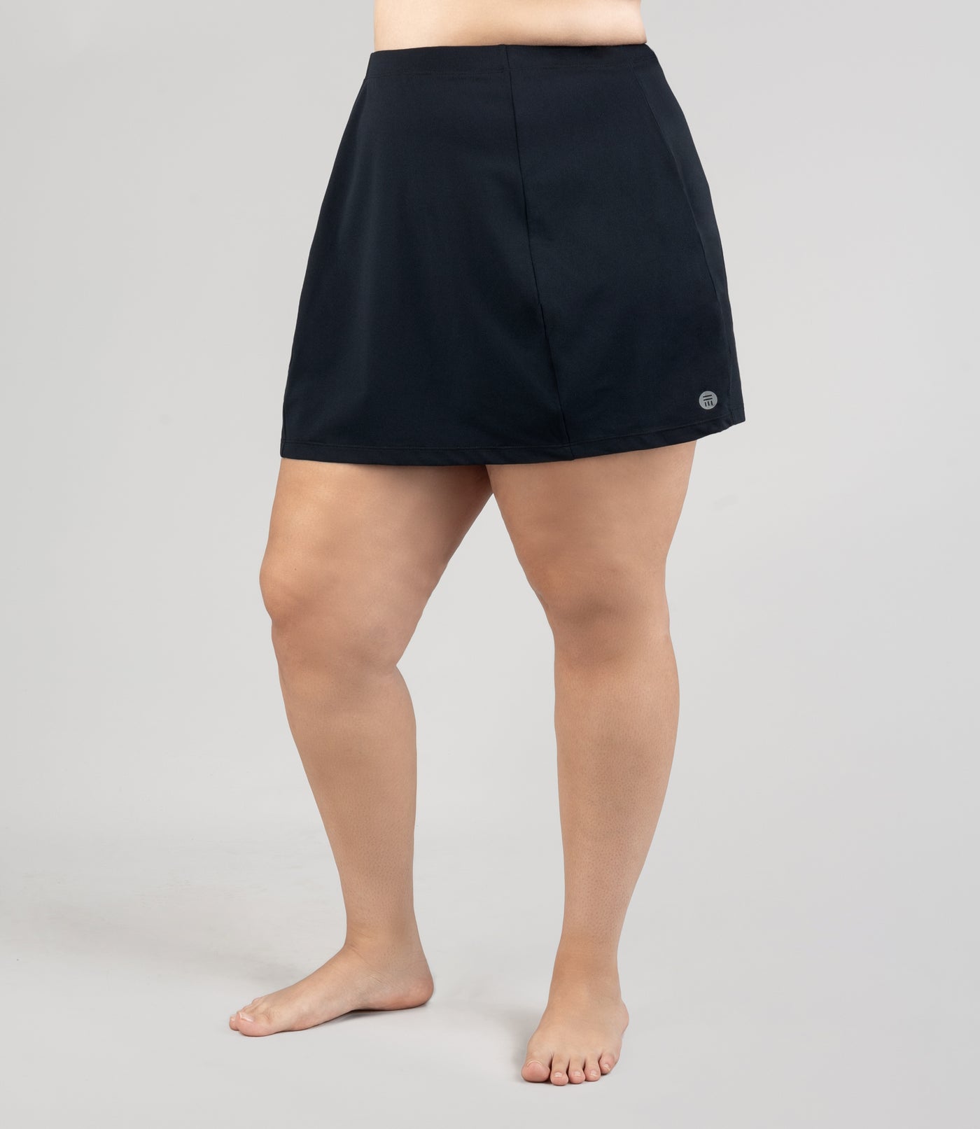 Model wearing JunoActive's Aquasport Swim Cover Skirt in color black.