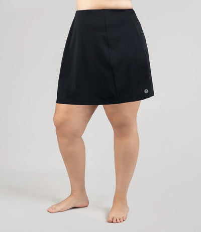 Model wearing JunoActive's Aquasport Swim Cover Skirt in color black.