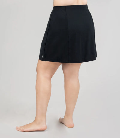 Model, facing back, is wearing JunoActive's Aquasport Swim Cover Skirt in color black.