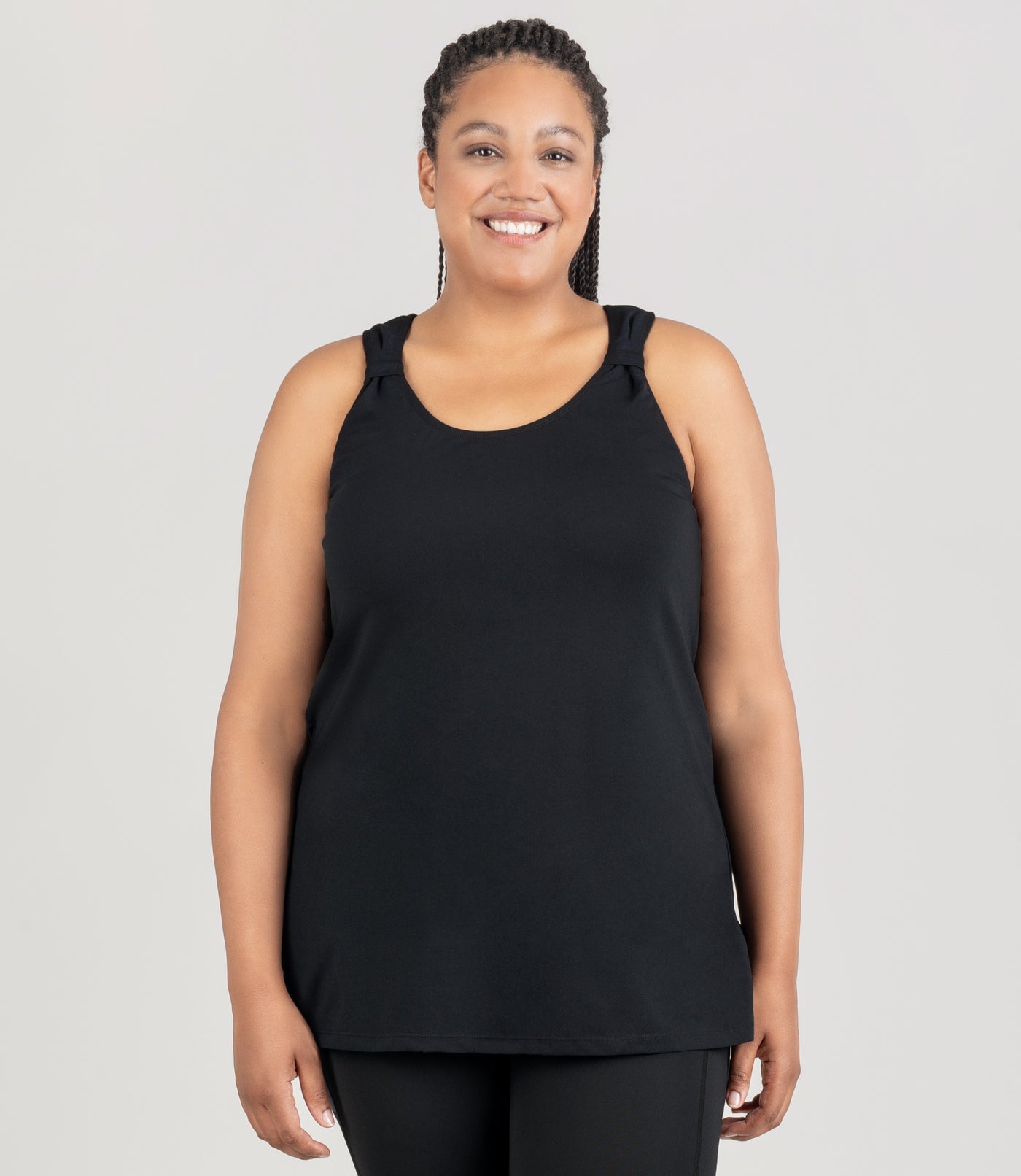 JunoActive model is wearing an Aquasport Hanalei Tankin top in color black. Her arms are by her side.