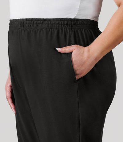 Plus size model, facing front close up, wearing JunoActive's Softwik Pear plus size Pant in color black.