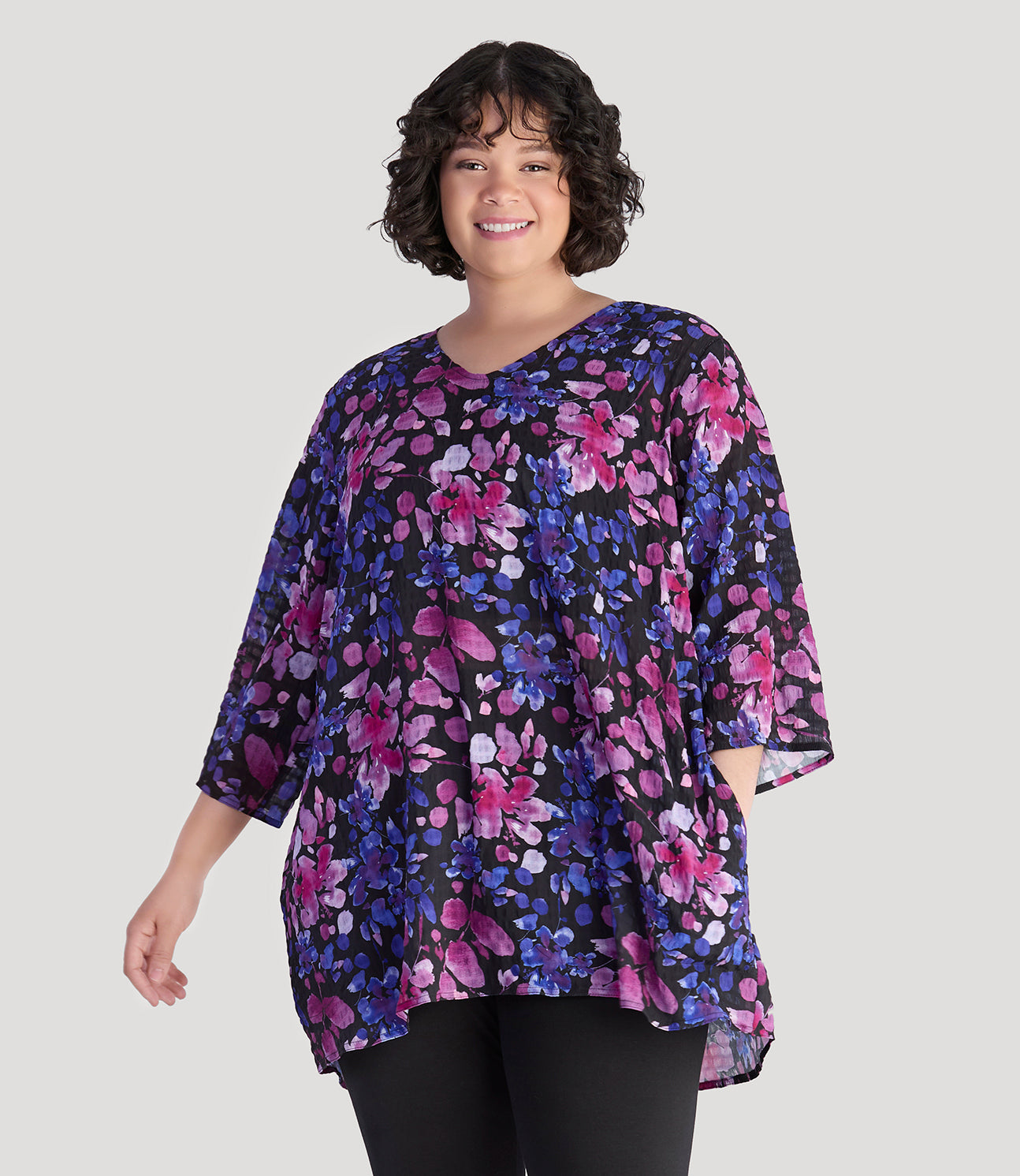 Plus size model, facing front, wearing JunoActive's BellaStyle Tunic Cover-up in floral elegance print.
