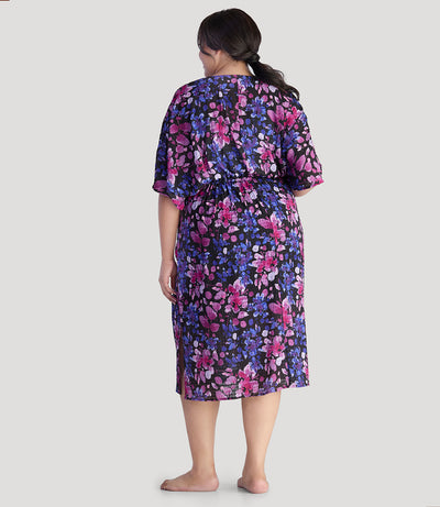 Plus size model, facing back, wearing JunoActive's BellaStyle V-Neck Long Gathered Caftan in floral elegance print.