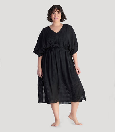Plus size model, facing front, wearing JunoActive's BellaStyle V-Neck Long Gathered Caftan in color black.