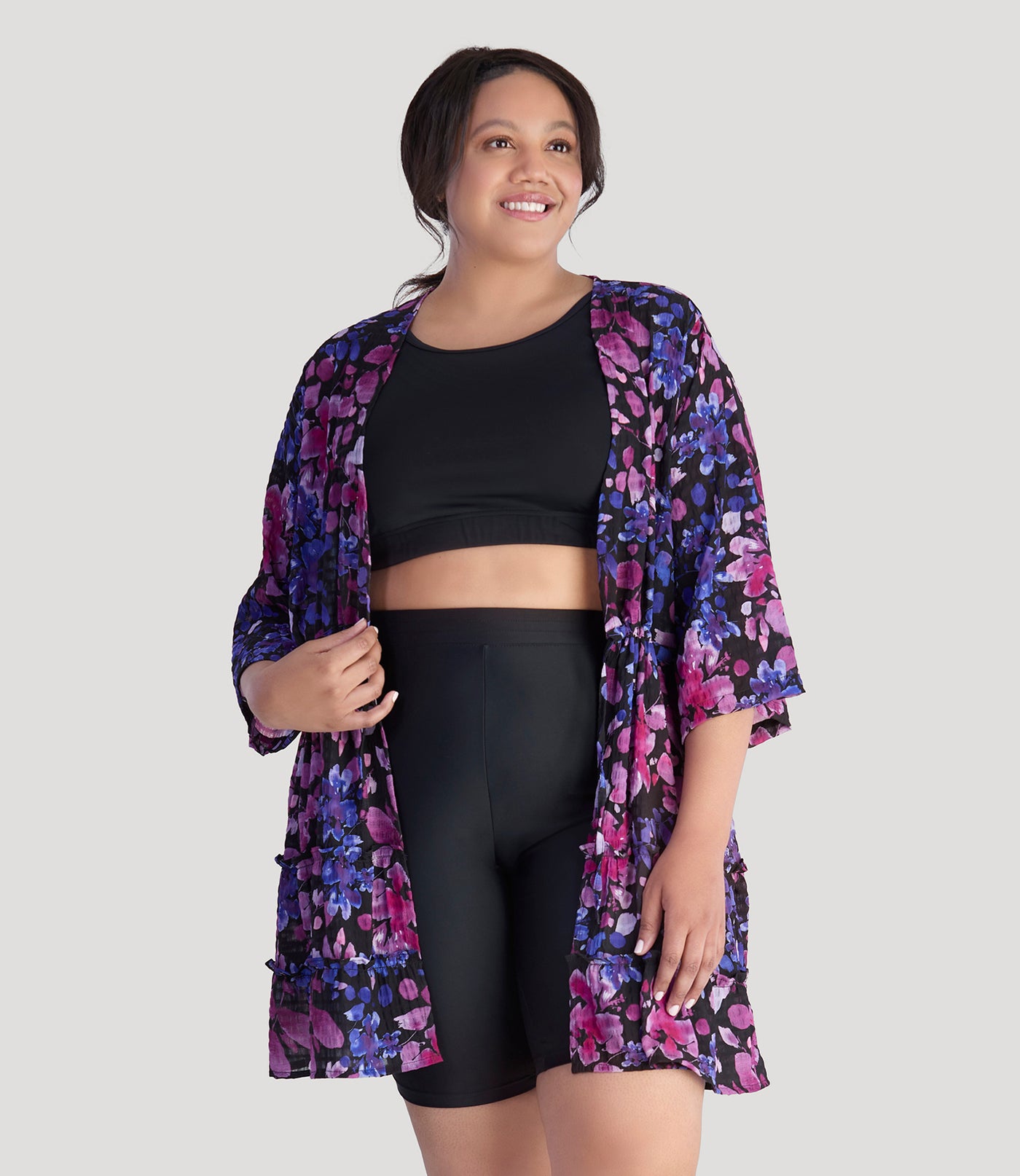  Plus size model, facing front, wearing JunoActive's BellaStyle Tie Front Tiered Cover-Up in floral elegance print.