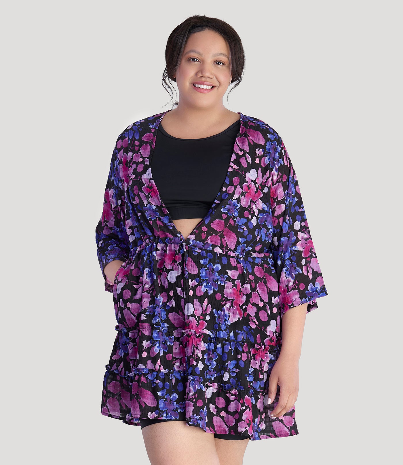 Plus size model, facing front, wearing JunoActive's BellaStyle Tie Front Tiered Cover-Up in floral elegance print.