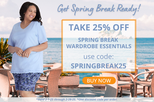 Plus size model smiling looking over her shoulder wearing JunoActive plus size clothing, a light blue short sleeve top and a pair of shorts in a blue, white and black small floral print. The background is an outdoor dining area overlooking the sea. Take 25% off spring break essentials with code springbreak25 this offer is valid through the month of February.